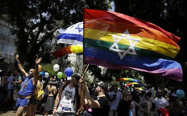 Israelis and tourists wave flags as they participate in the Gay Pride parade in Tel Aviv, June 8, 2018. (AP/Sebastian Scheiner) Israelis and tourists wave flags as they participate in the Gay Pride parade in Tel Aviv, June 8, 2018. (AP/Sebastian Scheiner)