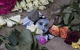 Roses cover the photo of the 14-year-old Susanna Maria Feldman killed in Wiesbaden, Germany, June 8, 2018 (Boris Roessler/dpa via AP)