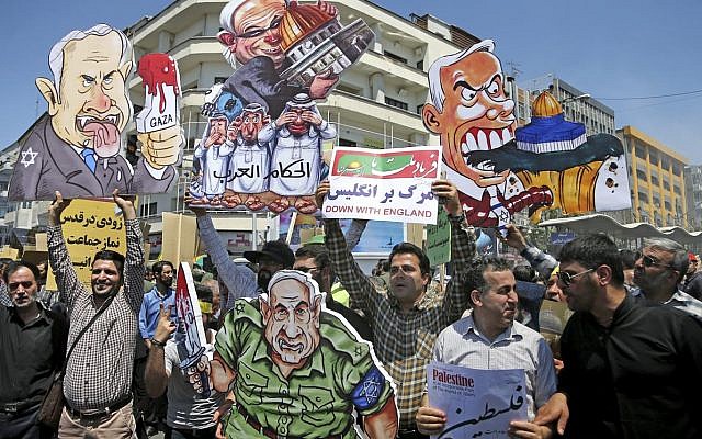 Illustrative: Iranian protesters hold up caricatures of leaders of Israel during the annual anti-Israeli Al-Quds, Jerusalem, Day rally in Tehran, Iran, Friday, June 8, 2018 (AP Photo/Ebrahim Noroozi)