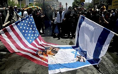 Iranian protesters burn Israeli and US flags in their annual anti-Israeli Al-Quds, Jerusalem, Day rally in Tehran, Iran, Friday, June 8, 2018 (AP Photo/Ebrahim Noroozi)