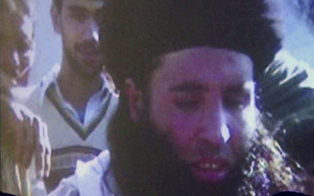 In this image made from video broadcast on November 7, 2013, undated footage of Mullah Fazlullah is shown on a projector in Pakistan (AP Photo via AP Video, File)