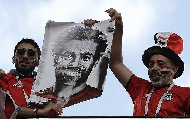 Egyptian supporters lift a photo of national soccer team player Mohamed Salah ahead the group A match between Egypt and Uruguay at the 2018 soccer World Cup in the Yekaterinburg Arena in Yekaterinburg, Russia, Friday, June 15, 2018. (AP Photo/Mark Baker) Egyptian supporters lift a photo of national soccer team player Mohamed Salah ahead the group A match between Egypt and Uruguay at the 2018 soccer World Cup in the Yekaterinburg Arena in Yekaterinburg, Russia, Friday, June 15, 2018. (AP Photo/Mark Baker)