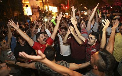 Iranians celebrate the 1-0 victory of their national soccer team over Morocco in the 2018 World Cup, in downtown Tehran, Iran, Friday, June 15, 2018. (AP Photo/Vahid Salemi)