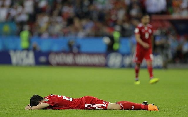 Iran's Sardar Azmoun lies flat out on the ground after the end of the group B match between Iran and Spain at the 2018 soccer World Cup in the Kazan Arena in Kazan, Russia, Wednesday, June 20, 2018. (AP/Sergei Grits) Iran's Sardar Azmoun lies flat out on the ground after the end of the group B match between Iran and Spain at the 2018 soccer World Cup in the Kazan Arena in Kazan, Russia, Wednesday, June 20, 2018. (AP/Sergei Grits)