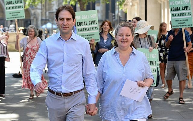 Rebecca Steinfeld (l) and Charles Keidan outside the Supreme Court in London, where they have won their fight for the right to enter into a civil partnership, Thursday June 27, 2018. (Kirsty O'Connor/PA via AP) Rebecca Steinfeld (l) and Charles Keidan outside the Supreme Court in London, where they have won their fight for the right to enter into a civil partnership, Thursday June 27, 2018. (Kirsty O'Connor/PA via AP)