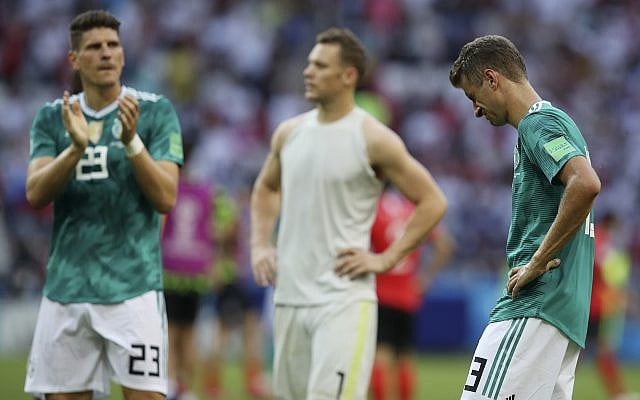 From right, Germany's Thomas Mueller, goalkeeper Manuel Neuer and Mario Gomez walk on the pitch at the end of the group F match between South Korea and Germany, at the 2018 soccer World Cup in the Kazan Arena in Kazan, Russia, June 27, 2018. (AP Photo/Thanassis Stavrakis)