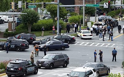 Maryland police officers block the intersection at the building entrance, after multiple people were shot at a newspaper in Annapolis, Md., June 28, 2018. (AP Photo/Jose Luis Magana)