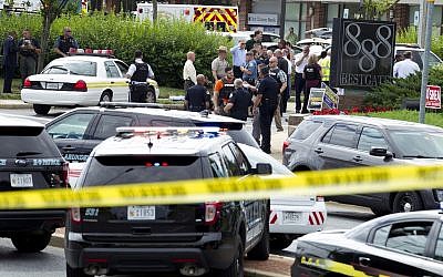 Authorities stage at the office building entrance after multiple people were shot at The Capital Gazette newspaper in Annapolis, Md., June 28, 2018. (AP Photo/Jose Luis Magana)