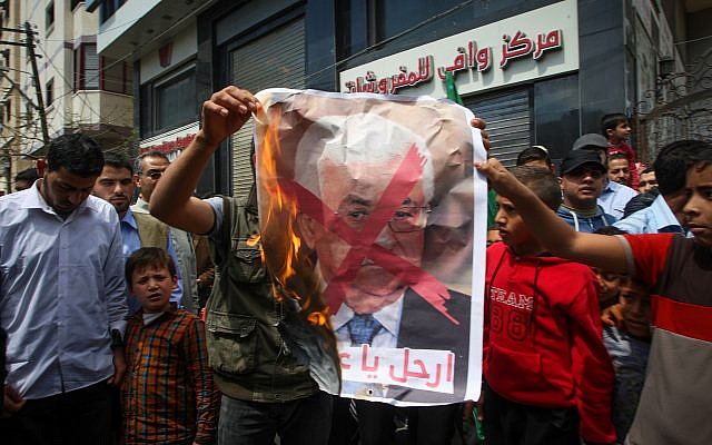 Palestinians burn a poster of Palestinian Authority President Mahmoud Abbas during a protest against Israel and the PA in Khan Younis in the southern Gaza Strip on April 14, 2017. (Abed Rahim Khatib/Flash90) Palestinians burn a poster of Palestinian Authority President Mahmoud Abbas during a protest against Israel and the PA in Khan Younis in the southern Gaza Strip on April 14, 2017. (Abed Rahim Khatib/Flash90)