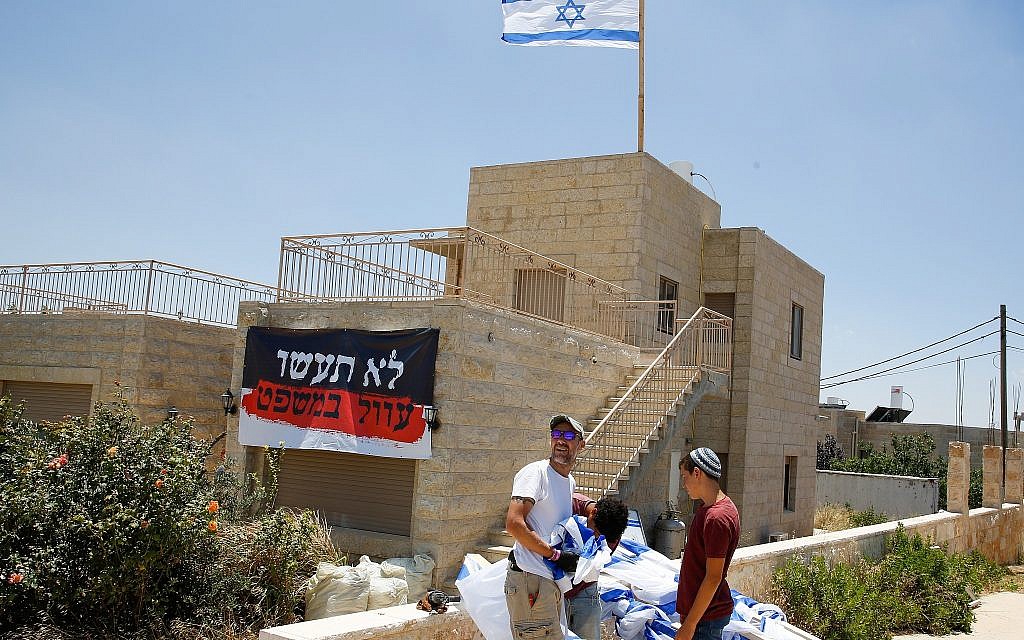 People seen near a home slated for demolition in the illegal Jewish neighborhood of Netiv Ha'avot on June 11, 2018. (Gershon Elinson/Flash90) People seen near a home slated for demolition in the illegal Jewish neighborhood of Netiv Ha'avot on June 11, 2018. (Gershon Elinson/Flash90)