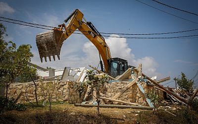 A bulldozer demolishes a homes in the Netiv Ha'avot outpost on June 13, 2018. (Gershon Elinson/Flash90)