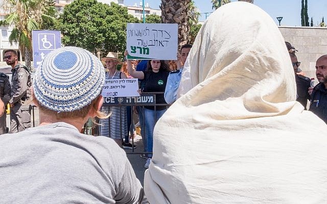 Right wing supporters watch a protest outside a court hearing in Lod on the Duma attack, June 19, 2018. (Roy Alima/Flash90) Right wing supporters watch a protest outside a court hearing in Lod on the Duma attack, June 19, 2018. (Roy Alima/Flash90)