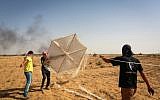 Palestinians prepare a kite with flammable materials that they will fly into southern Israel from Rafah, in the southern Gaza Strip, on June 22, 2018. (Abed Rahim Khatib/Flash90)