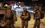 Israeli soldiers stand near the scene of a suspected car-ramming attack at the entrance to the Palestinian village og Husan, in the West Bank, on June 23, 2018.  (Nati Shohat/Flash90)