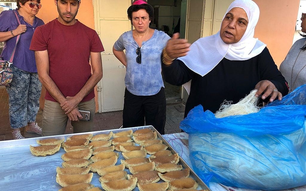 In Kafr Qara, Amna Kanana explains how to prepare traditional filled Ramadan sweets called katayif, June 2018. (Amanda Borschel-Dan/Times of Israel)