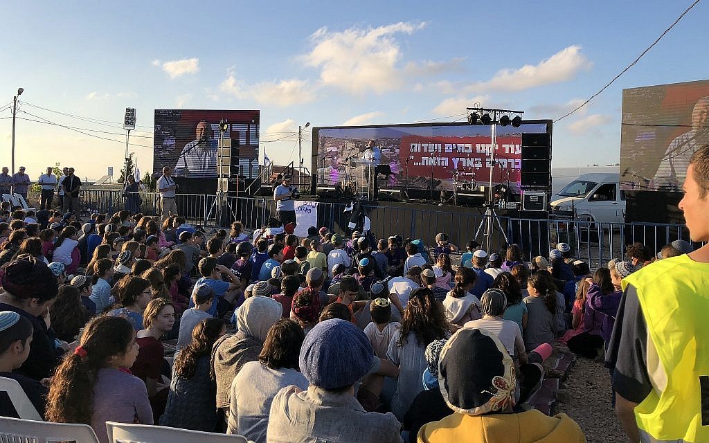 Some two thousand Israelis attend a protest rally at the West Bank outpost of Netiv Ha'avot on June 11, 2018, ahead of its scheduled demolition. (Jacob Magid/Times of Israel)
