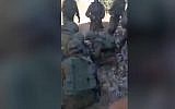 Screen capture from video allegedly showing IDF soldiers attending to injured Palestinian man Azzedine Tamimi who shot by troops in the West Bank village of Nebi Saleh, June 6, 2018. (YouTube)