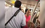 A screenshot from a video of Shauntaye King yelling at Yossi Wolfe on a New York City subway car. (Screen capture: YouTube)