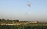 Incendiary balloons being launched into Israel from the Gaza Strip in May 2018. (Screen capture: Quds news)