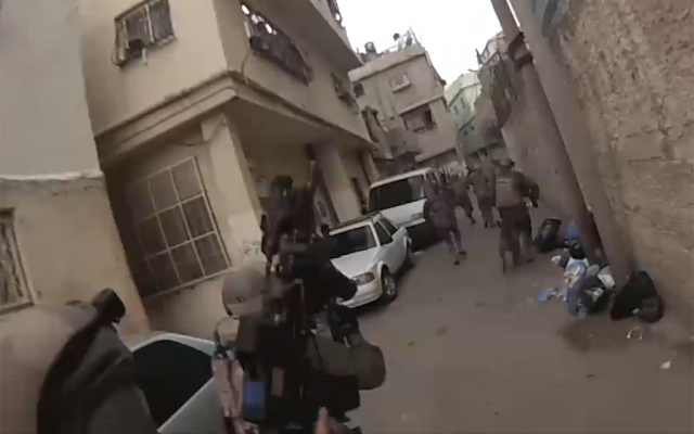 Israeli troops on June 6, 2018, arrest a Palestinian man suspected of killing an IDF soldier by dropping a stone slab on his head in the al-Am'ari refugee camp in Ramallah the month before. (Screen capture: Israel Defense Forces) Israeli troops on June 6, 2018, arrest a Palestinian man suspected of killing an IDF soldier by dropping a stone slab on his head in the al-Am'ari refugee camp in Ramallah the month before. (Screen capture: Israel Defense Forces)