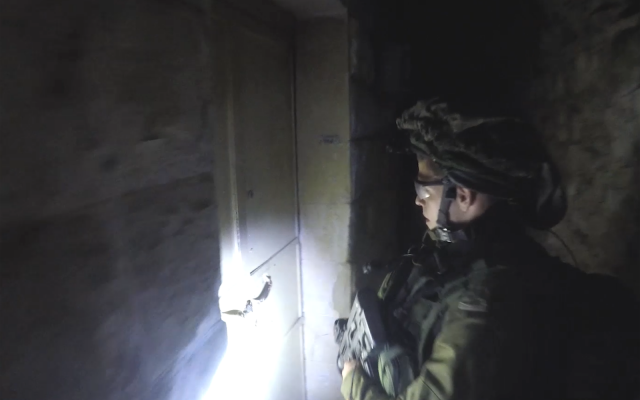 An IDF soldier arrests a member of a suspected Hamas cell in Nablus, in the northern Gaza Strip in April 2018. (Shin Bet) An IDF soldier arrests a member of a suspected Hamas cell in Nablus, in the northern Gaza Strip in April 2018. (Shin Bet)
