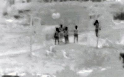 Alleged Hamas members carrying incendiary balloons to the Gaza border where they presumably launched them toward Israeli territory, from footage released by Israel on June 24, 2018. (Israel Defense Forces)