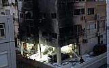 An apartment burning in Netanya that was torched on June 2, 2018 following a dispute between residents over a parking spot. (Israel Police)