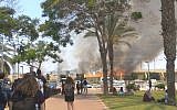 Illustrative: Students at Sderot's Sapir College watch as a large fire breaks out near Kibbutz Nir Am in southern Israel, which was apparently caused by a 'fire kite' from the Gaza Strip, on June 5, 2018. (Tair Alush)