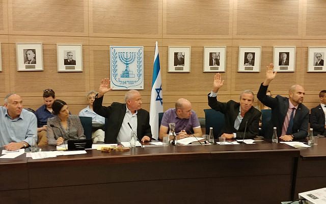 Members of the Knesset Defense and Foreign Affairs Committee vote in favor of a bill to slash funds to the Palestinian Authority by the amount Ramallah pays out to convicted terrorists, June 11, 2018. (Courtesy) Members of the Knesset Defense and Foreign Affairs Committee vote in favor of a bill to slash funds to the Palestinian Authority by the amount Ramallah pays out to convicted terrorists, June 11, 2018. (Courtesy)