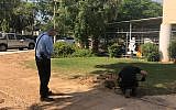 A police sapper digs up a rocket fired from Gaza that landed outside a kindergarten in one of the communities of the Eshkol region on June 20, 2018. (Eshkol region)