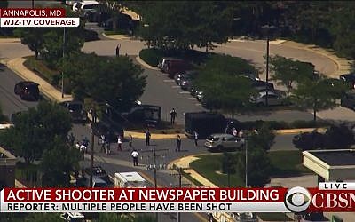 People leave the building of The Capital newspaper in Annapolis, Maryland after shooting on June 28, 2018. (Screen capture: CBSN)
