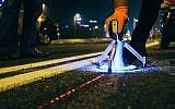 On the Ayalon Highway, workers lay out smart studs developed by Israeli startup Valerann (Courtesy)