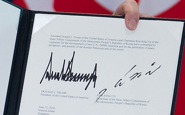 The signatures of US President Donald Trump (L) and North Korea's leader Kim Jong Un (R) are seen on a document held up by Trump following a signing ceremony during their historic US-North Korea summit, at the Capella Hotel on Sentosa island in Singapore, on June 12, 2018. ( AFP PHOTO / SAUL LOEB) The signatures of US President Donald Trump (L) and North Korea's leader Kim Jong Un (R) are seen on a document held up by Trump following a signing ceremony during their historic US-North Korea summit, at the Capella Hotel on Sentosa island in Singapore, on June 12, 2018. ( AFP PHOTO / SAUL LOEB)