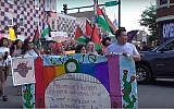 Participants in the 2018 Chicago Dyke March waving Palestinian flags. (Screen capture: Windy City Times)