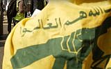 An anti-Israel protester wears the flag of the Lebanon-based terror organization Hezbollah during Quds Day in London on June 18, 2017. (YouTube screenshot)