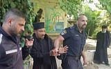 Screenshot from Channel 10 News shows police officers removing a handcuffed Ethiopian monk from an Ethiopian Church-owned property in Jerusalem, on May 31, 2018,