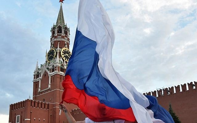 A young Russia fan holds the national flag at the Red Square in Moscow on July 1, 2018, after Russia won the Russia 2018 World Cup round of 16 football match against Spain. (AFP PHOTO / Vasily MAXIMOV) A young Russia fan holds the national flag at the Red Square in Moscow on July 1, 2018, after Russia won the Russia 2018 World Cup round of 16 football match against Spain. (AFP PHOTO / Vasily MAXIMOV)