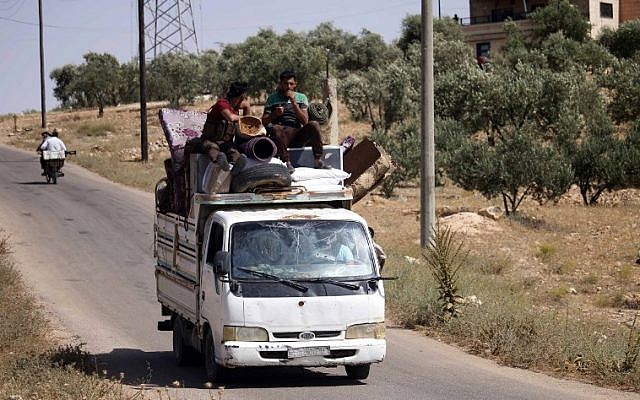 Displaced Syrians flee from government forces' bombardment on rebel-held areas of the embattled southern city of Daraa on July 3, 2018. (AFP/Mohamad ABAZEED) Displaced Syrians flee from government forces' bombardment on rebel-held areas of the embattled southern city of Daraa on July 3, 2018. (AFP/Mohamad ABAZEED)