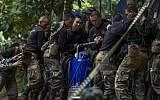 Thai soldiers carry equipment during rescue operations for 12 boys and their coach trapped in Tham Luang cave in Thailand on July 4, 2018 (AFP PHOTO / YE AUNG THU)
