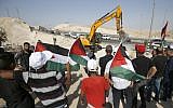 Demonstrators wave Palestinian flags as they protest against the upcoming demolition of the West Bank Bedouin village of Khan al-Ahmar on July 4, 2018. (AFP Photo/Abbas Momani)