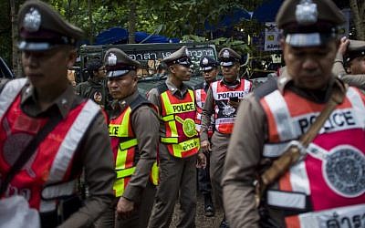 Illustrative: Thai policemen stand guard outside a cave during a rescue operation for 12 boys and their coach trapped in the cave at the Khun Nam Nang Non Forest Park in the Mae Sai district of Chiang Rai province, Thailand on July 4, 2018. (AFP PHOTO / YE AUNG THU)