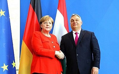 German Chancellor Angela Merkel (L) shakes hands with Hungarian Prime Minister Viktor Orban during a joint press conference following a meeting on July 5, 2018 in Berlin. (AFP PHOTO / Omer MESSINGER)