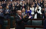 Turkish President Tayyip Erdogan greets members of parliament from his ruling AK Party (AKP) during a meeting at the Turkish parliament in Ankara, Turkey, July 7, 2018.   (AFP PHOTO / ADEM ALTAN)