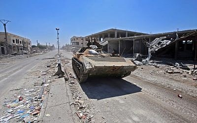 Syrian government soldiers ride in an infantry-fighting vehicle in the town of Saida in the west of Daraa province on July 7, 2018. (Youssef Karwashan/AFP)