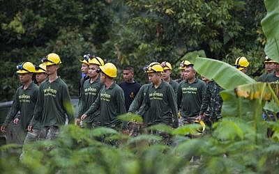 Thai soldiers walk out from the Tham Luang cave area as operations continue for the 8 boys and their coach trapped at the cave in Khun Nam Nang Non Forest Park in the Mae Sai district of Chiang Rai province on July 9, 2018. (AFP PHOTO / YE AUNG THU)