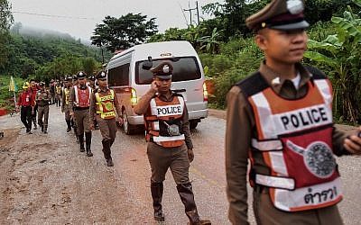 Thai policemen secure the road leading to Tham Luang cave area as rescue operations continue for those still trapped inside the cave in Khun Nam Nang Non Forest Park in the Mae Sai district of Chiang Rai province on July 9, 2018. (AFP PHOTO / YE AUNG THU
