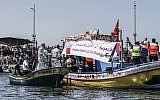 Activists escort a boat carrying Palestinians injured during clashes along the Gaza security fence as it tries to break through Israel's naval blockade from the Gaza City harbor on July 10, 2018 . (Mahmud Hams/AFP)