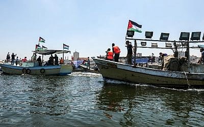 Illustrative: Activists escort a boat carrying Palestinians injured during clashes along the Gaza security fence as it tries to break through Israel's naval blockade from the Gaza City harbor on July 10, 2018 . (Mahmud Hams/AFP)
