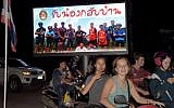 Motorists pass a billboard with a photograph showing members of the Thai children's football team "Wild Boar" and their coach with a message "welcome home brothers" displayed in Chiang Rai as the boys and their coach were all rescued in the Tham Luang cave in Khun Nam Nang Non Forest Park in the Mae Sai district on July 10, 2018. (AFP PHOTO / TANG CHHIN Sothy)