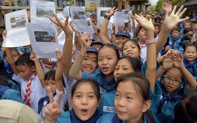 Thai students smile as they hold pictures of 12 boys and a football coach in front of the hospital where the group, who were rescued after being trapped in a nearby cave for 18 harrowing days, were brought for observation in the northern Thai city of Chiang Rai on July 11, 2018. (AFP Photo/Tang Chhin Sothy) Thai students smile as they hold pictures of 12 boys and a football coach in front of the hospital where the group, who were rescued after being trapped in a nearby cave for 18 harrowing days, were brought for observation in the northern Thai city of Chiang Rai on July 11, 2018. (AFP Photo/Tang Chhin Sothy)